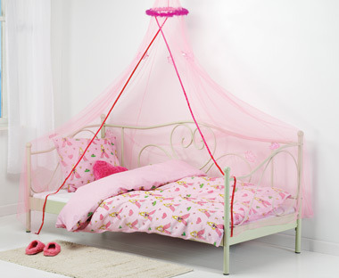 Pink bedding on top of child bed