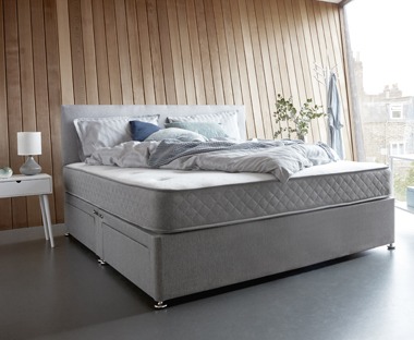 A double spring mattress in a contemporary room set up