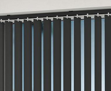 Charcoal grey vertical blinds adjusted to let in the daylight