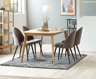 light grey patterned dining chairs and a wooden dining table 