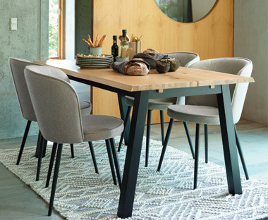 Light grey dining chairs and a wooden dining table 