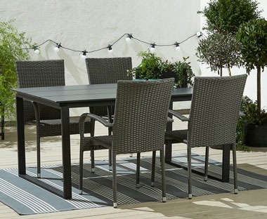 Black artwood garden dining table with grey polyrattan dining chairs