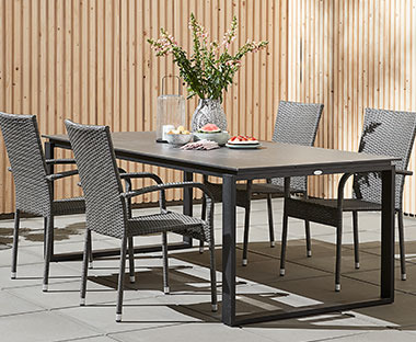 Rectangular artwood garden table in grey with metal frame legs and grey polyrattan garden chairs
