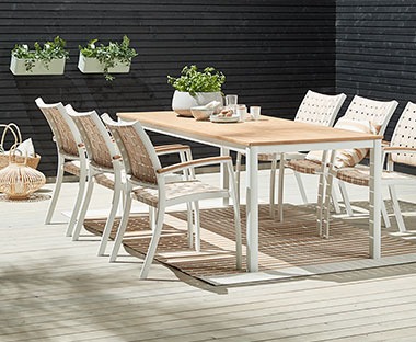 white wood and natural wooden table top with matching white garden chairs