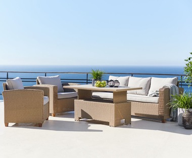 A nature coloured polyrattan 4 piece garden lounge set with natrual cushions two chairs, height adjustable table and sofa