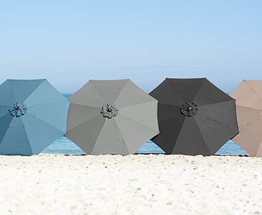 Parasols in blue, black and grey on a beach