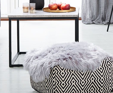A faux fur rug in grey