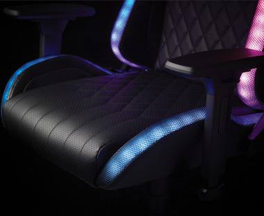 Black leather gaming chair with multicoloured LED's lighting up along the stitching