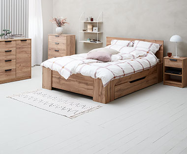 Bedroom with strong oak furniture including a bed and chest of drawers