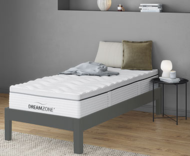 GOLD S100 Single mattress on a bedframe with a bedside table