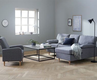 Grey chaise longue sofa with matching armchair and metal frame coffee table