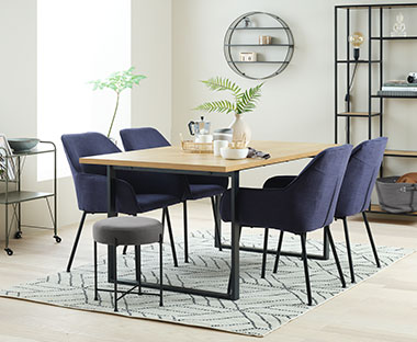 Metal frame wooden top table with dark blue upholstered dining chairs