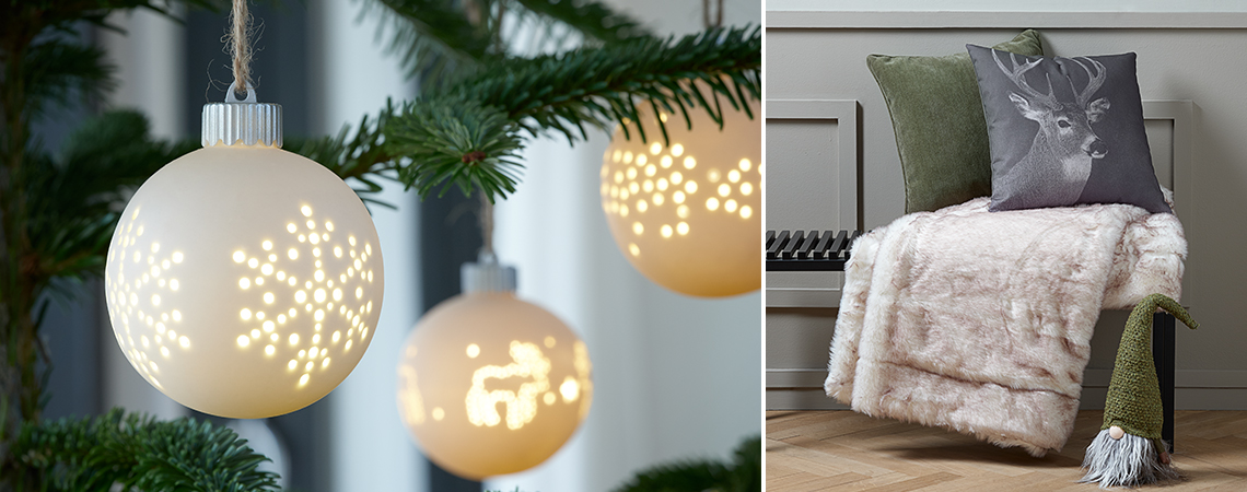 White baubles with LED in a Christmas tree and an elf in front of a bench with cushions and a throw 
