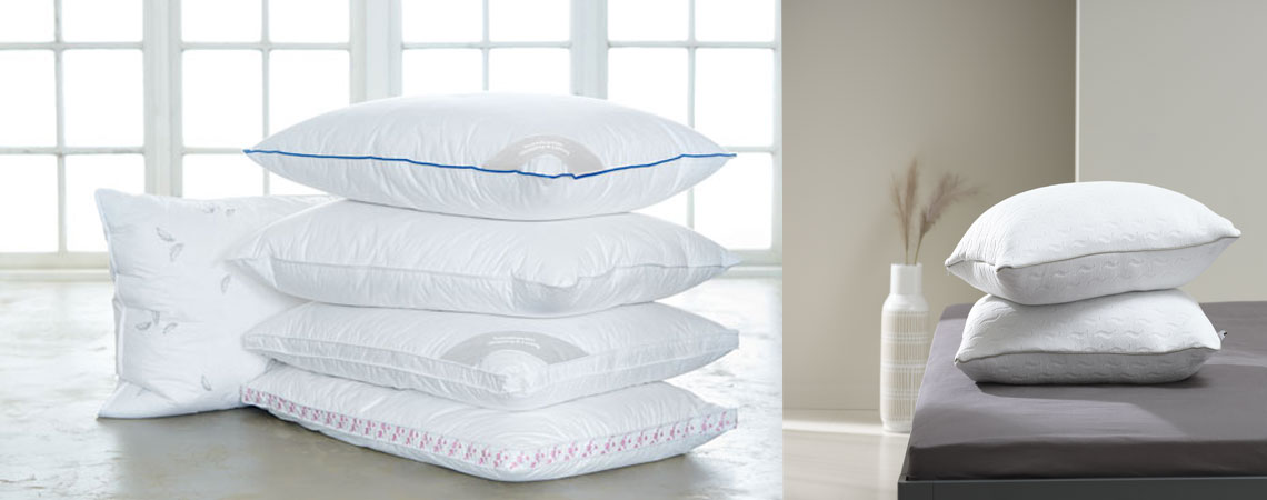 Natural and fibre filled pillows stacked on top of each other