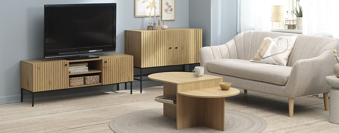 TV bench with a TV in a living room with sofa, coffee table and sideboard