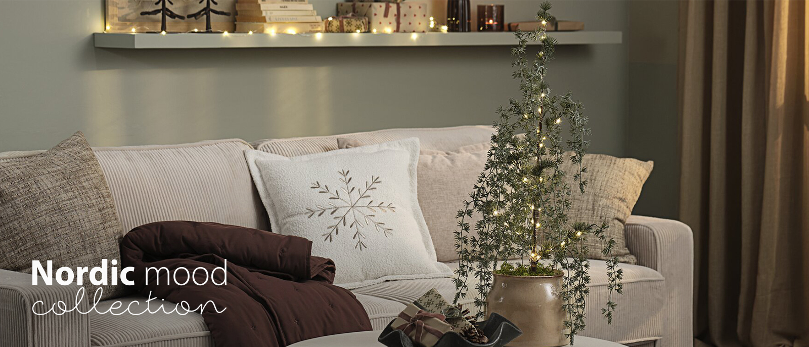 Sofa with cushions and throws in a living room decorated for Christmas 