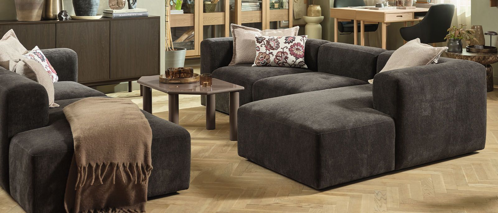 Dark brown modular corner sofa in large seating setup in living