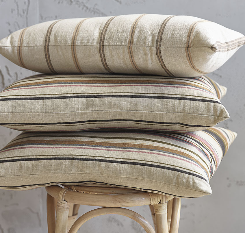Beige cushions with striped patterns in various mellow colours 