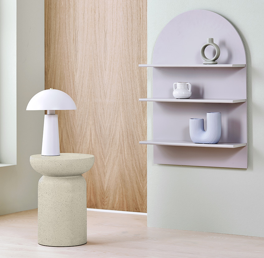 Small side table in beige, white classic lamp, and grey wall shelf with three shelves 