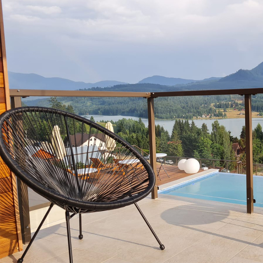 Furnished pool area with chair and mountains in background
