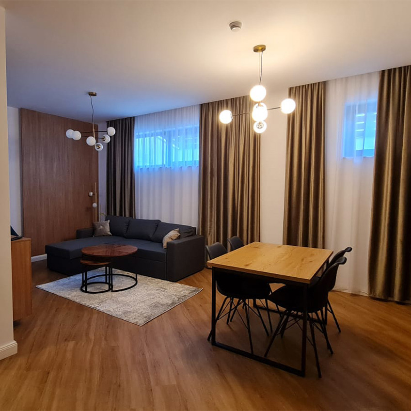 Furnished living room with table, couch, and decorations