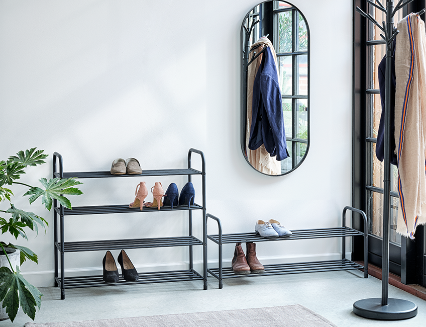 Two different black shoe racks: One with 4 shelves and one with 2.