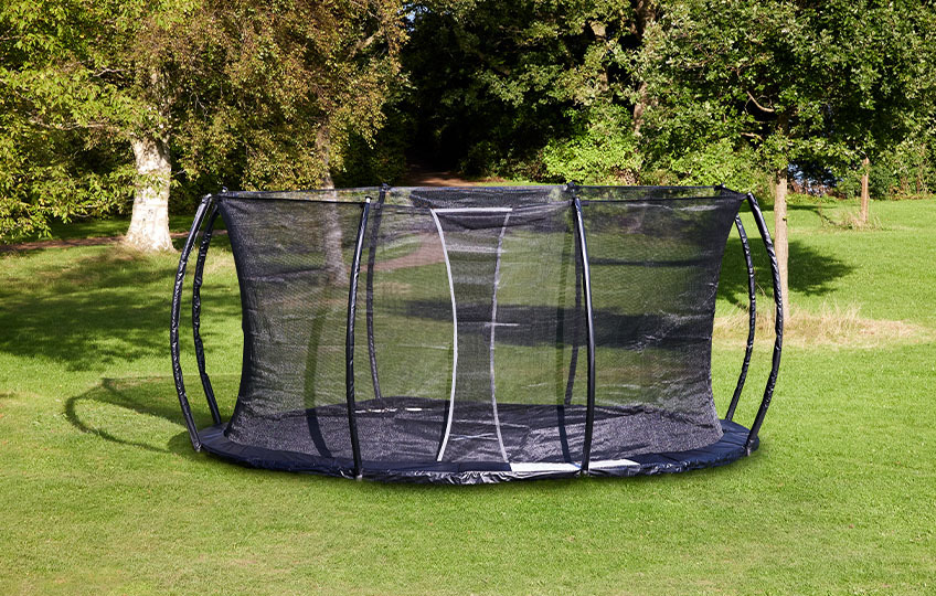 In-ground trampoline with safety net and padded outer edge
