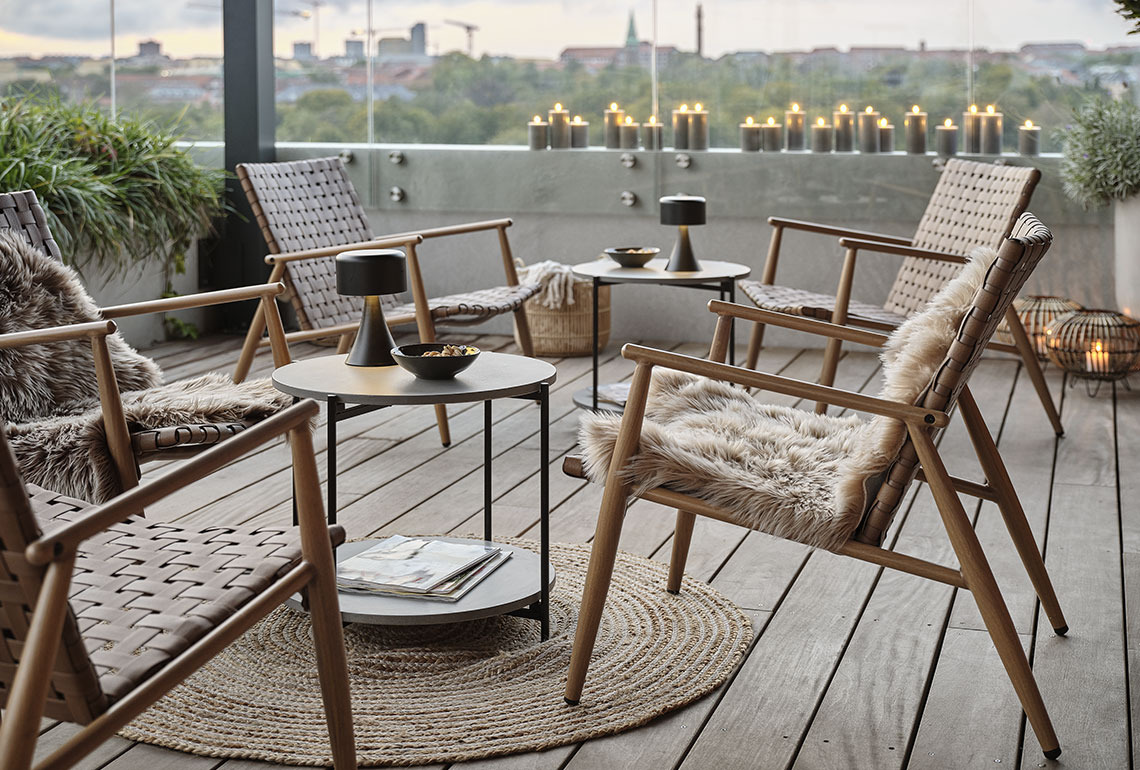 Garden lounge chairs and tables on a cosy balcony 