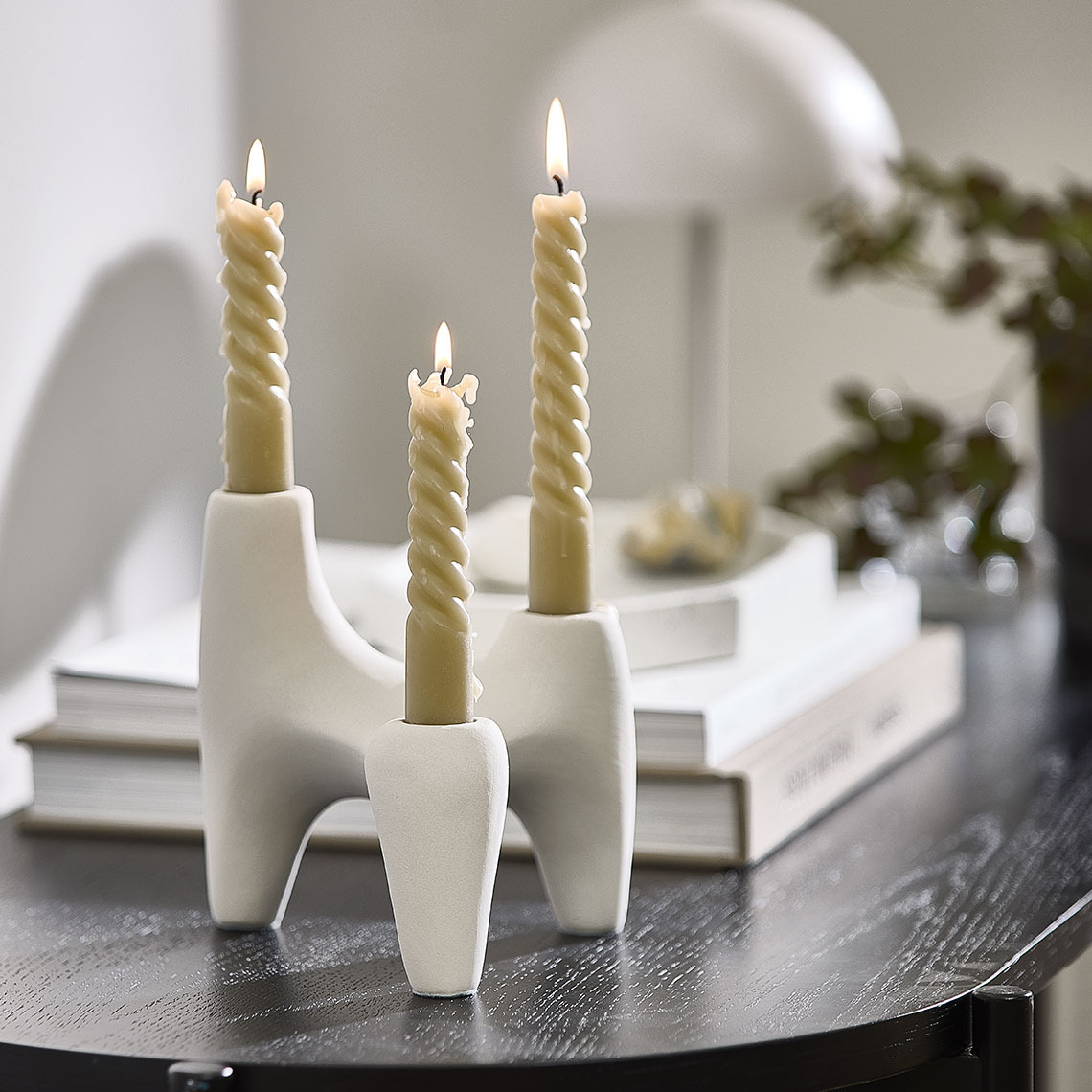 White candle holder with twisted candles 