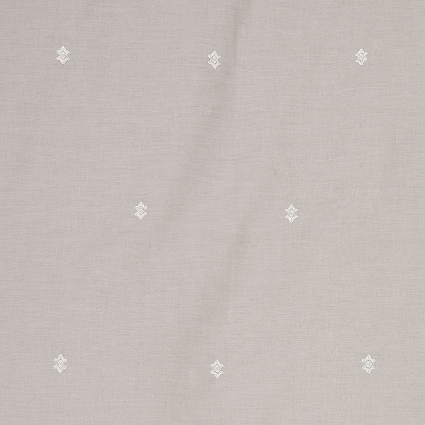 Closeup of embroidered details and white motifs on light grey duvet cover set