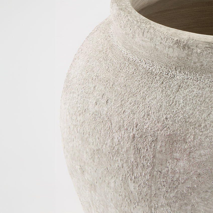 Close-up image of stoneware plant pot in light grey colour