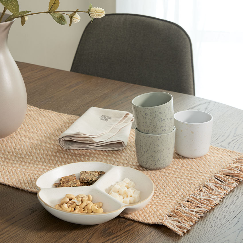Bowl and mugs on dining table 