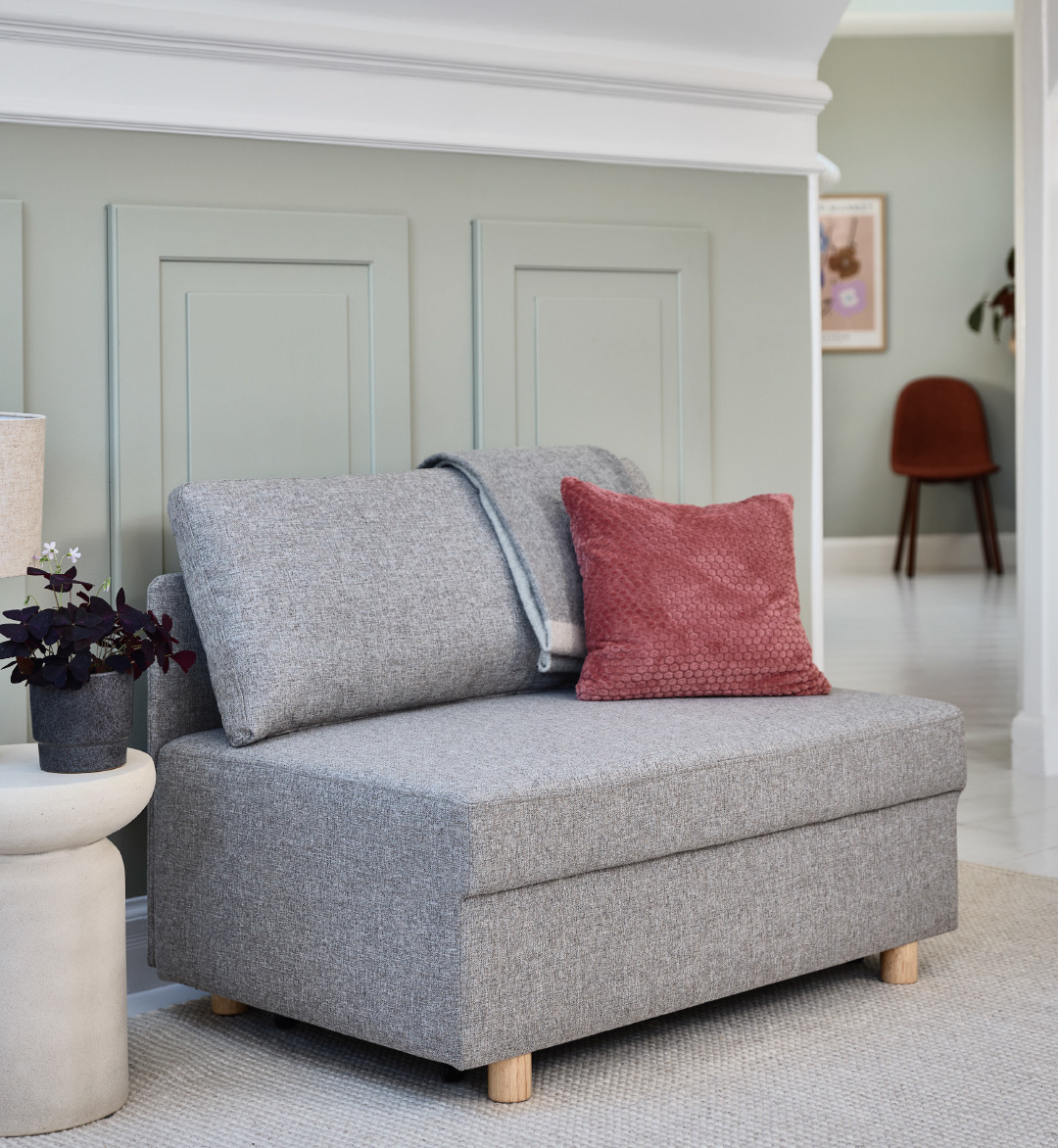 grey corner sofa with pink textured cushion