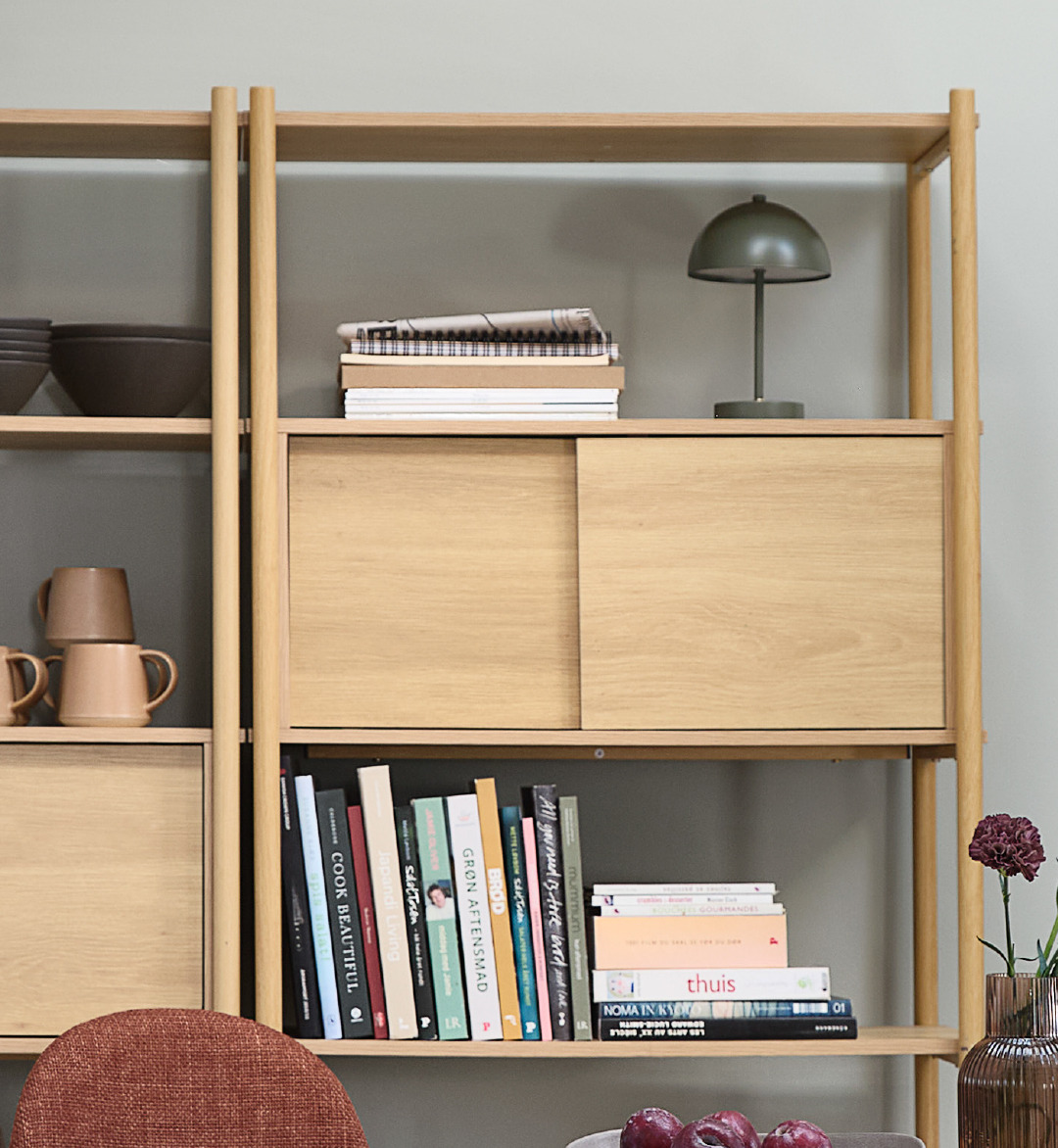 green battery lamp on wooden storage unit