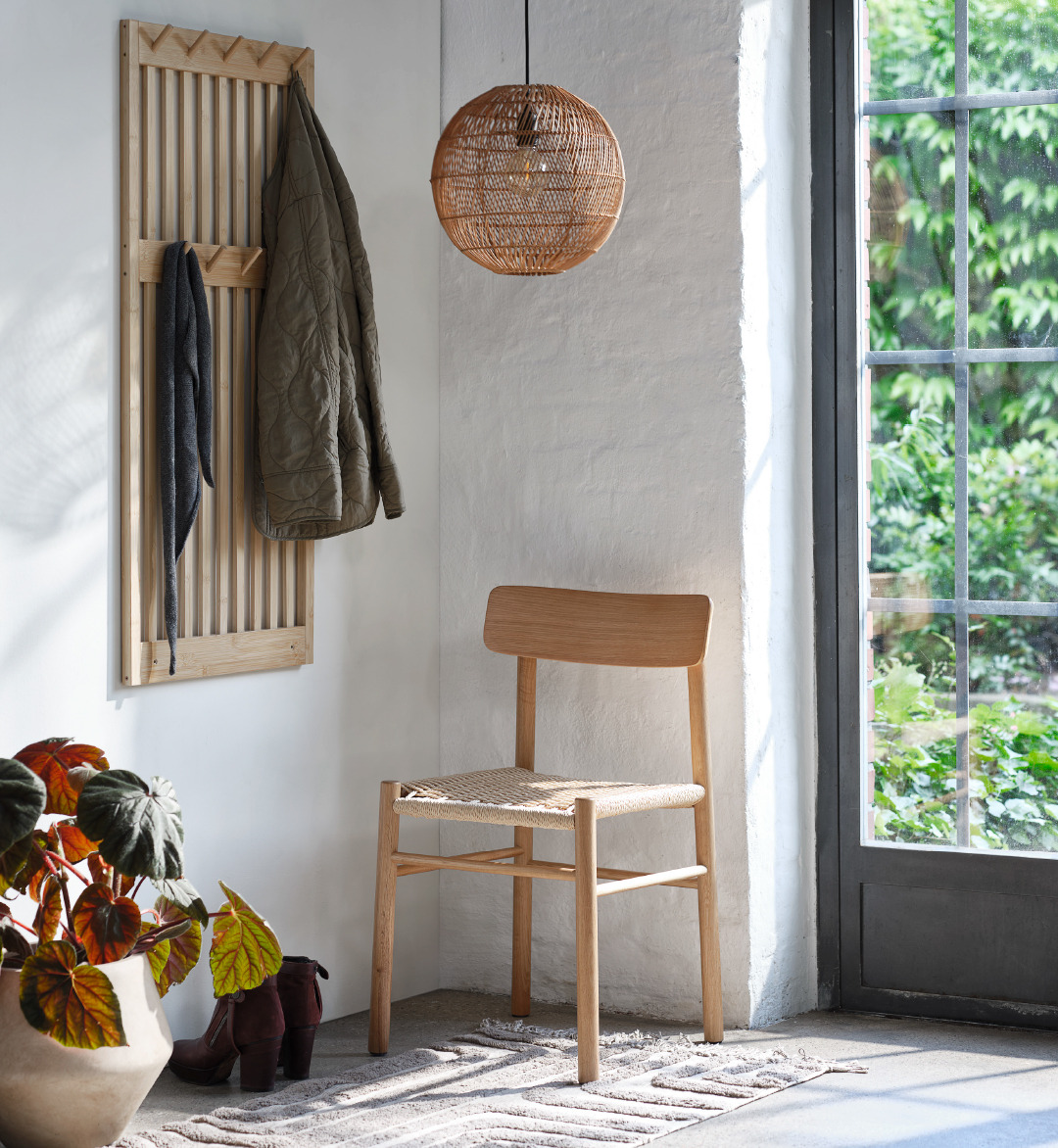 coat hanger, wooden chair and wicker light