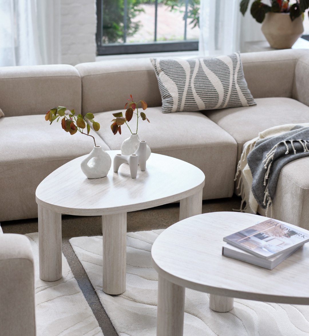 black abstract cushion and sand coffee table