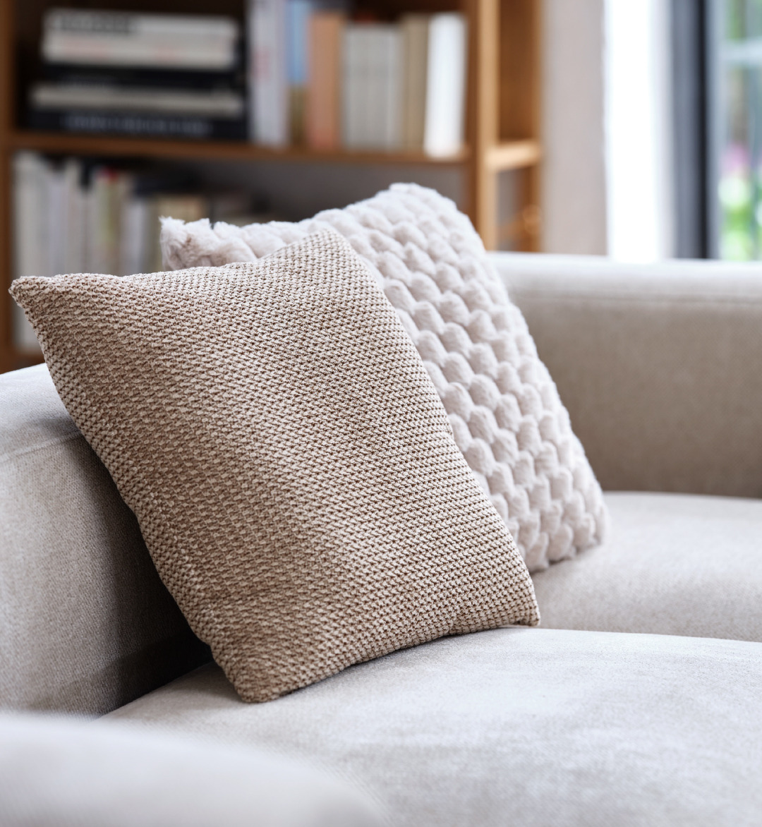 cream and brown cushion of grey couch