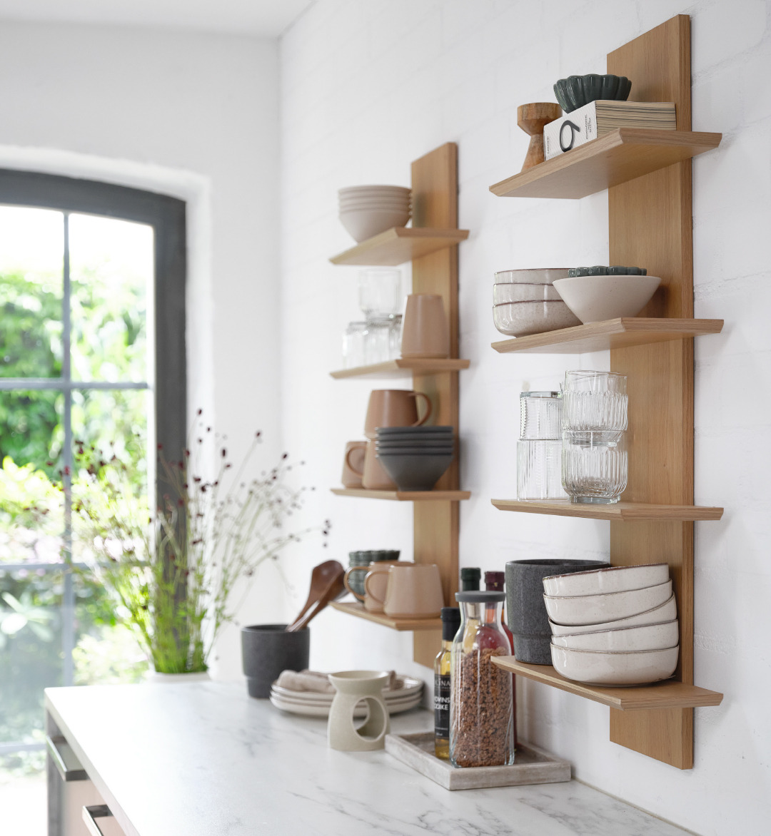 wooden wall shelf holding cups