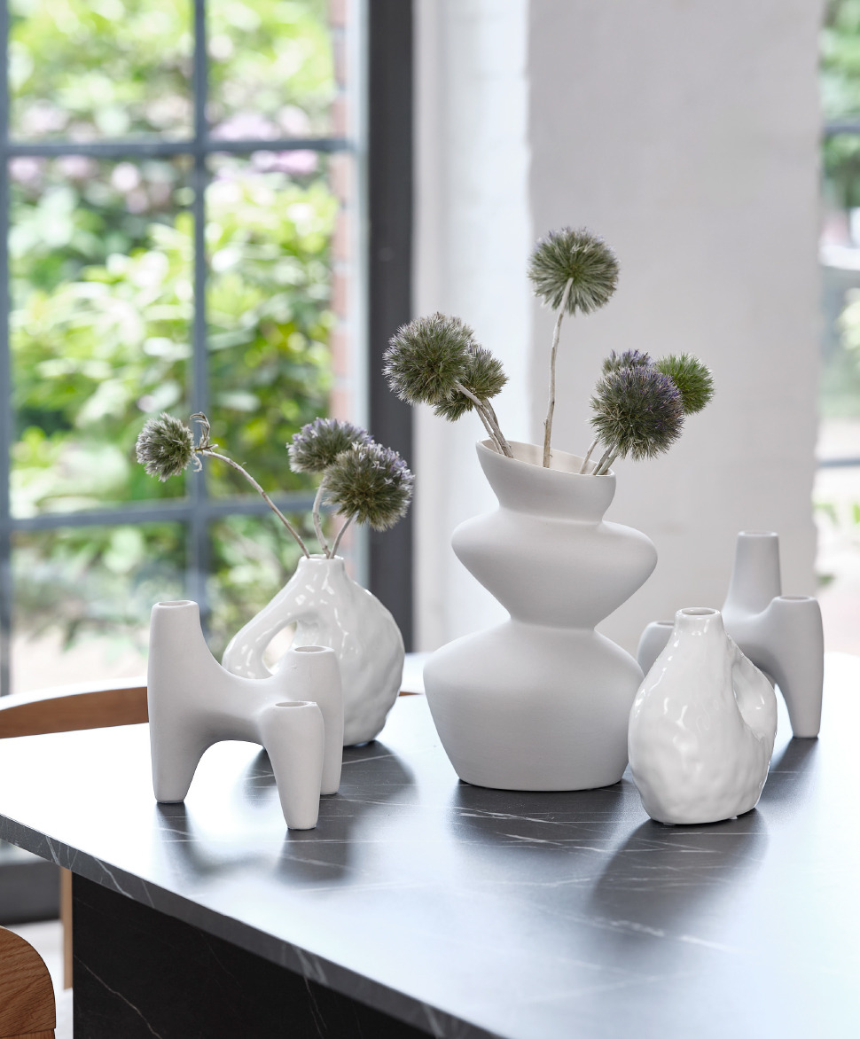 collection of white vases and candleholders