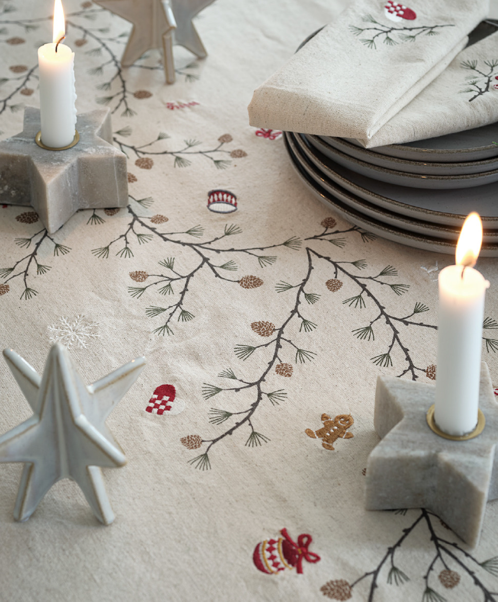 : A table decorated with lights and star shaped Christmas decorations 