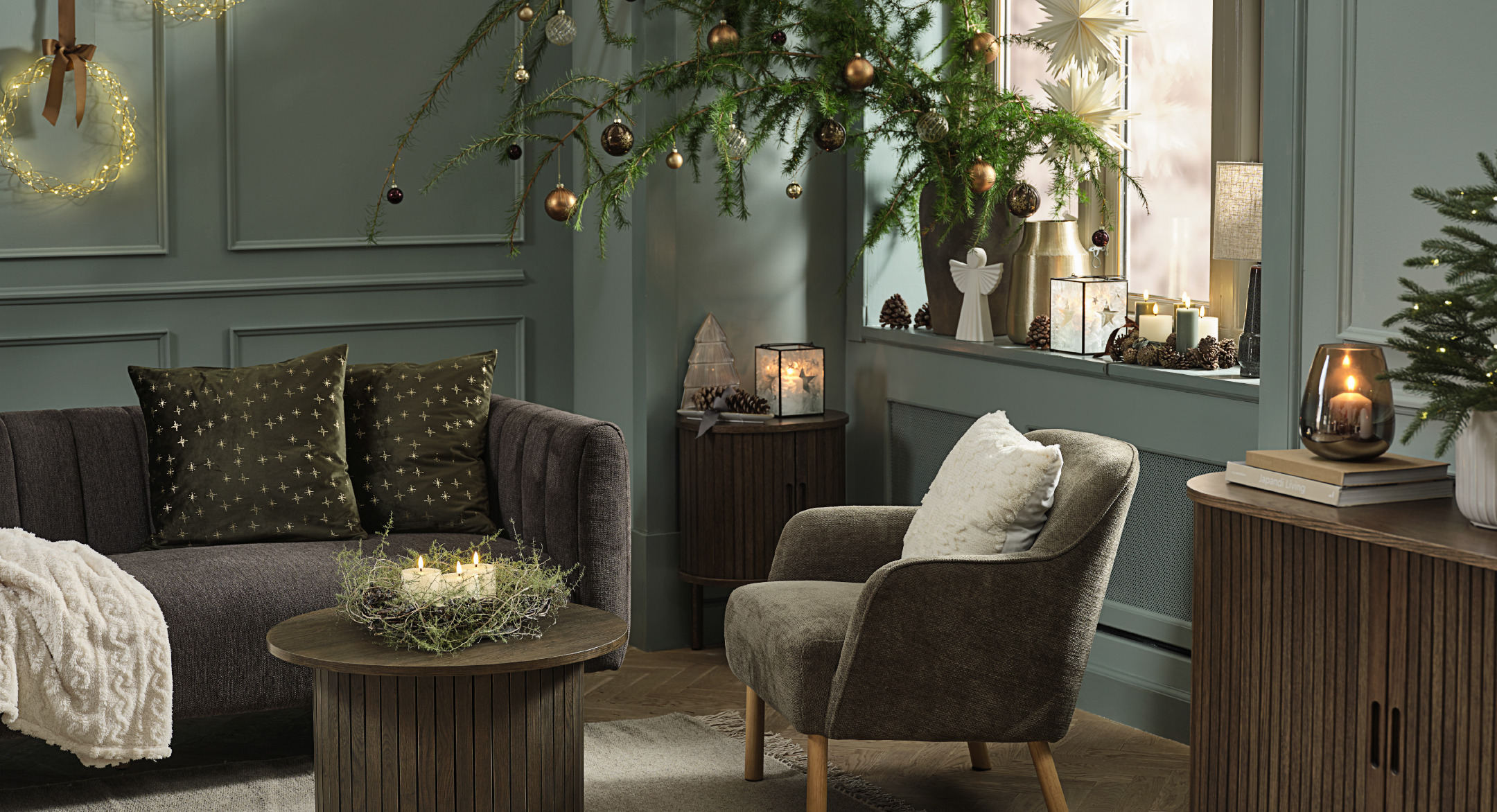 A green-painted living room decorated for Christmas