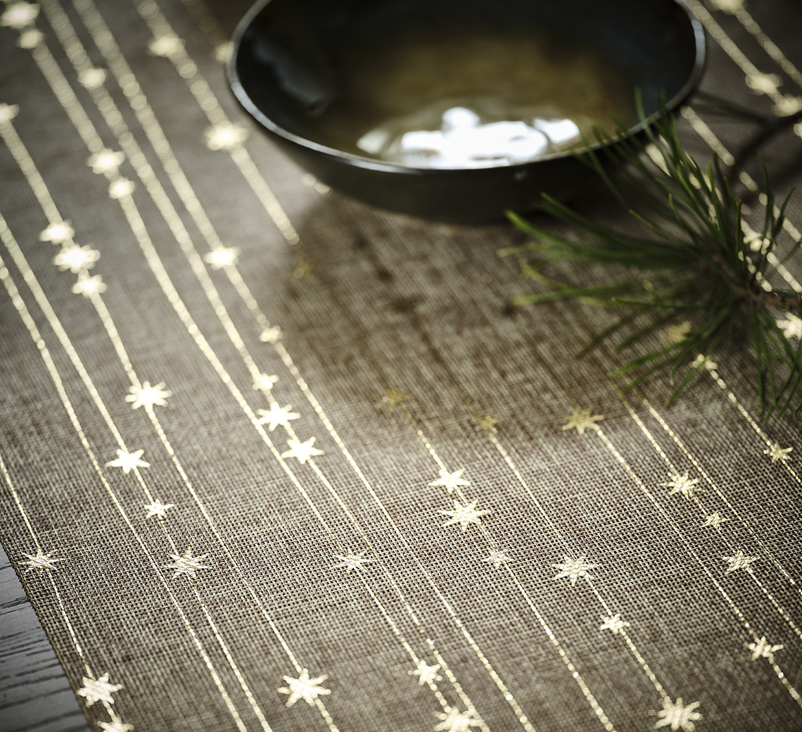 Dining table covered by a Christmas table runner