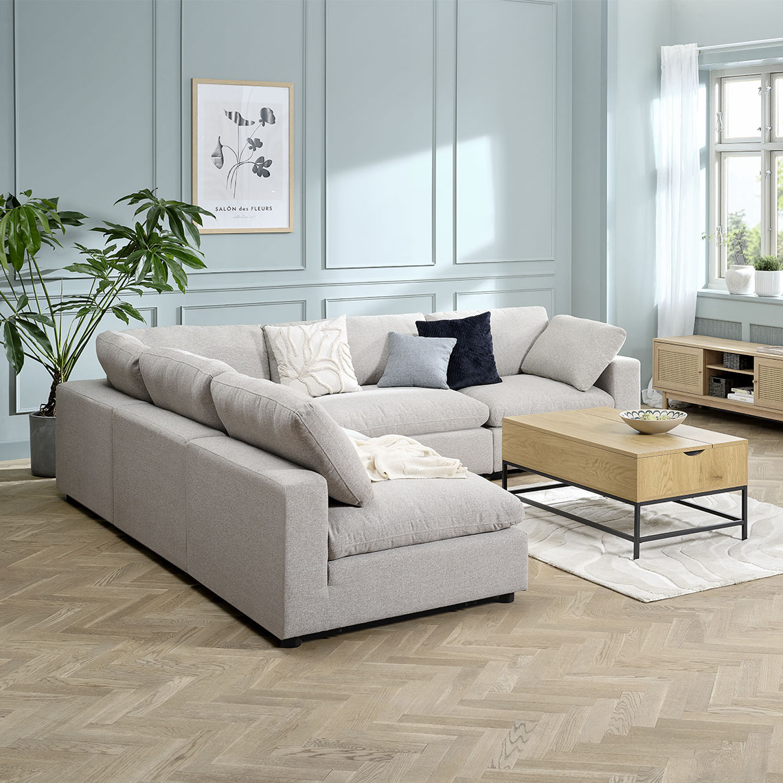 Beige modular corner sofa reconfigured as a L-shape in a living room area