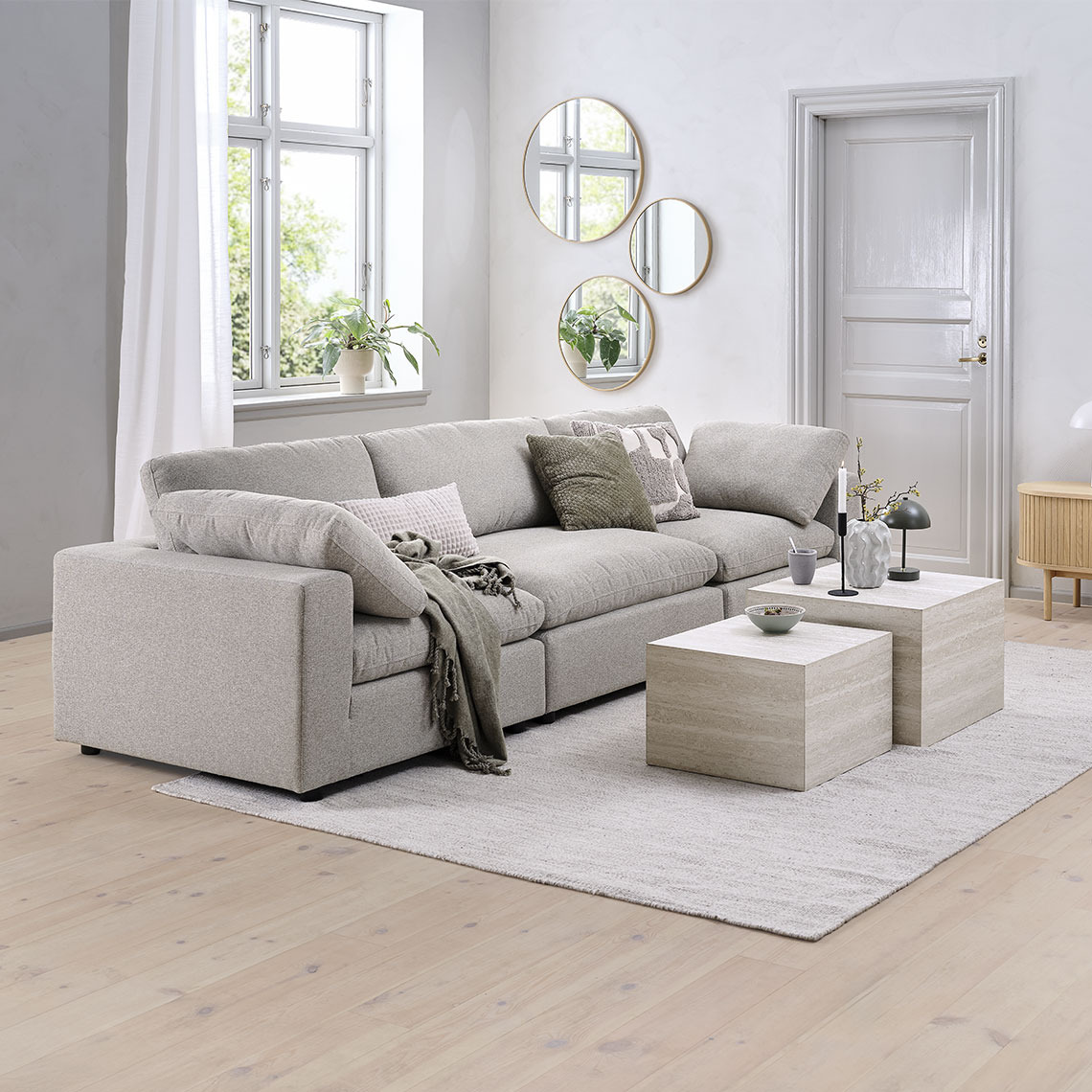 Beige modular sofa reconfigured to a 3-seater sofa in a living room area