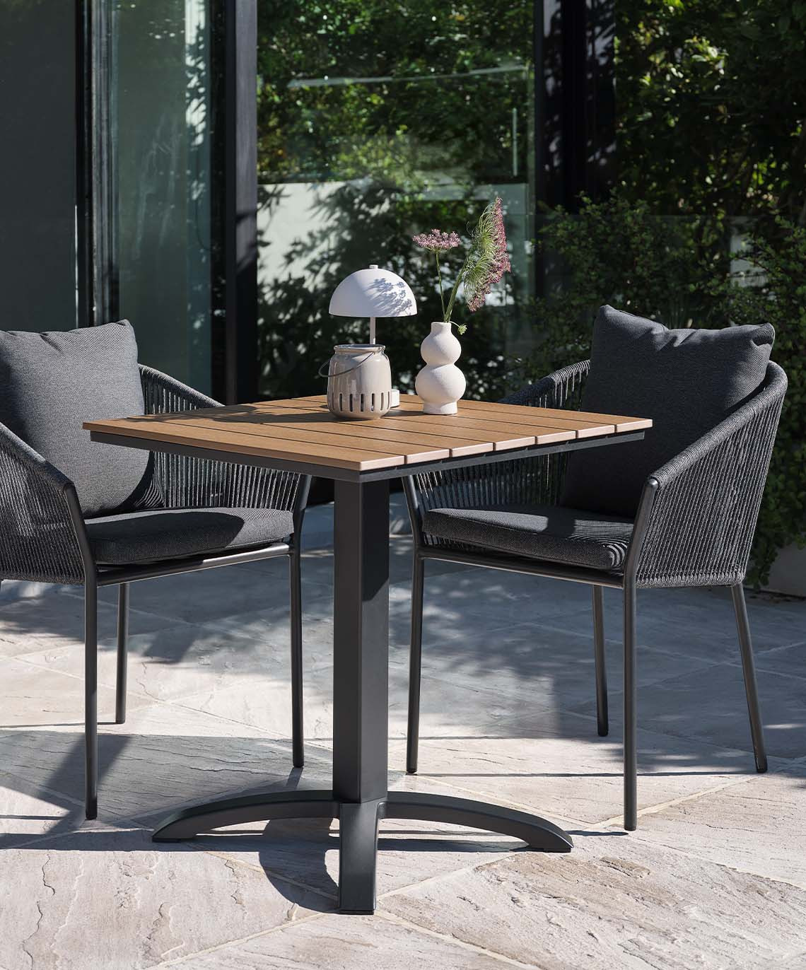 Outdoor table with artificial wood table top and chairs with quick-dry cushions