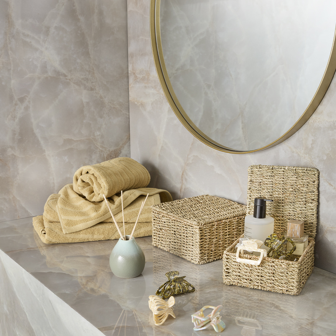 IDALA towels and SENNAN storage boxes Yellow cotton towels and bathroom organizers in a bathroom