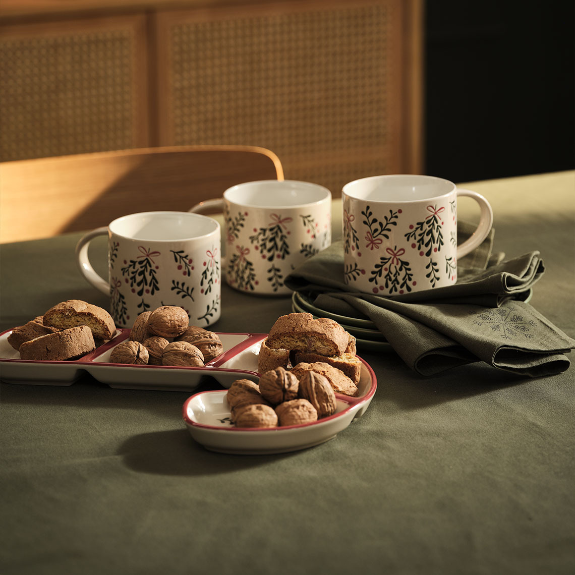 Christmas mugs, bowl and Christmas cloth napkins on a table 