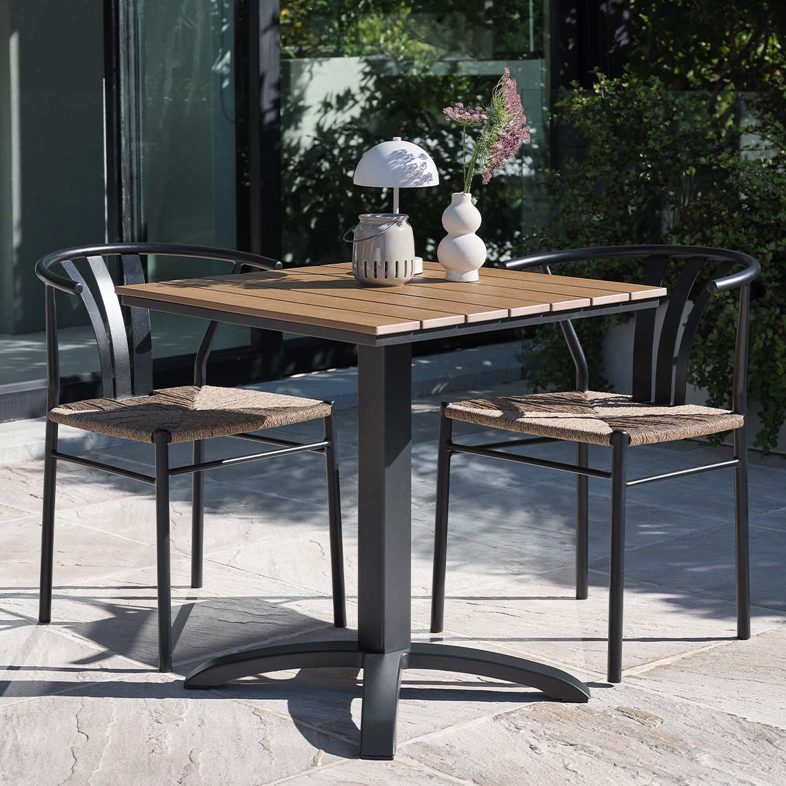 Maintenance-free HOBRO bistro table and TAGMARK garden chairs Maintenance-free garden table and garden chairs in modern style on patio