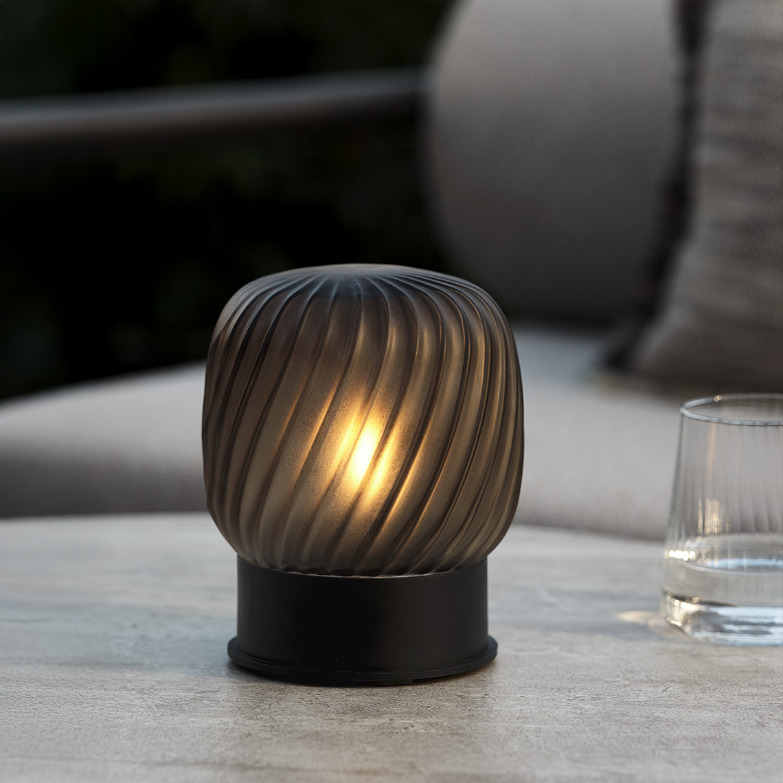 Battery-powered table lamp on garden table 