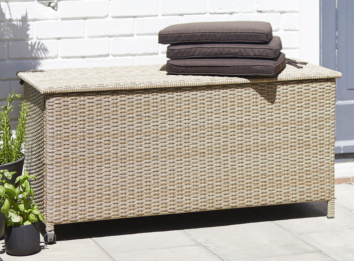 YDERUP cushion storage box with wheels and a handle Cushion storage box with handle and wheels on a sunny patio